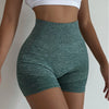 Woman wearing seamless high-waisted workout shorts in a slim, stretchy fit—ideal for yoga, gym, and activewear.