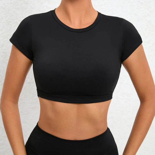Woman wearing a black backless workout crop top with breathable, stretchy fabric — perfect for running, gym workouts, cycling, and outdoor activities.