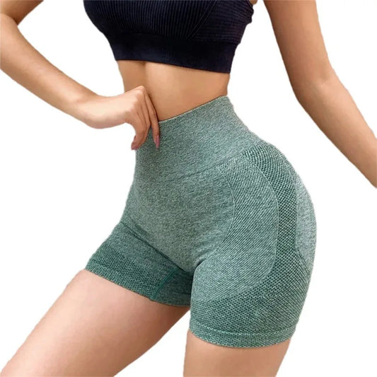 Woman wearing seamless high-waisted workout shorts in a slim, stretchy fit—ideal for yoga, gym, and activewear.