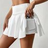 Woman wearing white high-waist skort with hidden pocket and built-in shorts