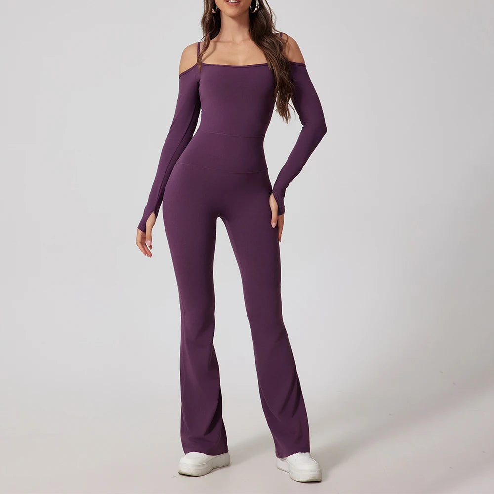 Woman wearing purple open-back summer jumpsuit with long sleeves and full-length legs.