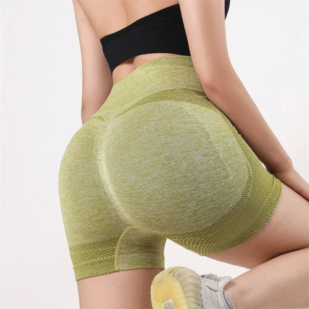Woman wearing seamless high-waisted workout shorts in a slim, stretchy fit—ideal for yoga, gym, and activewear.