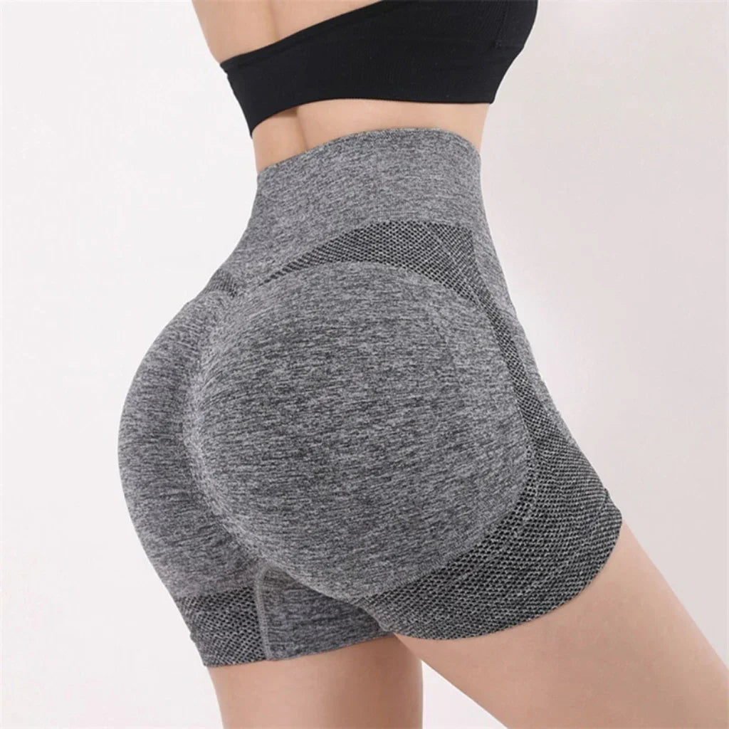 Woman wearing high waist workout shorts during a summer workout
