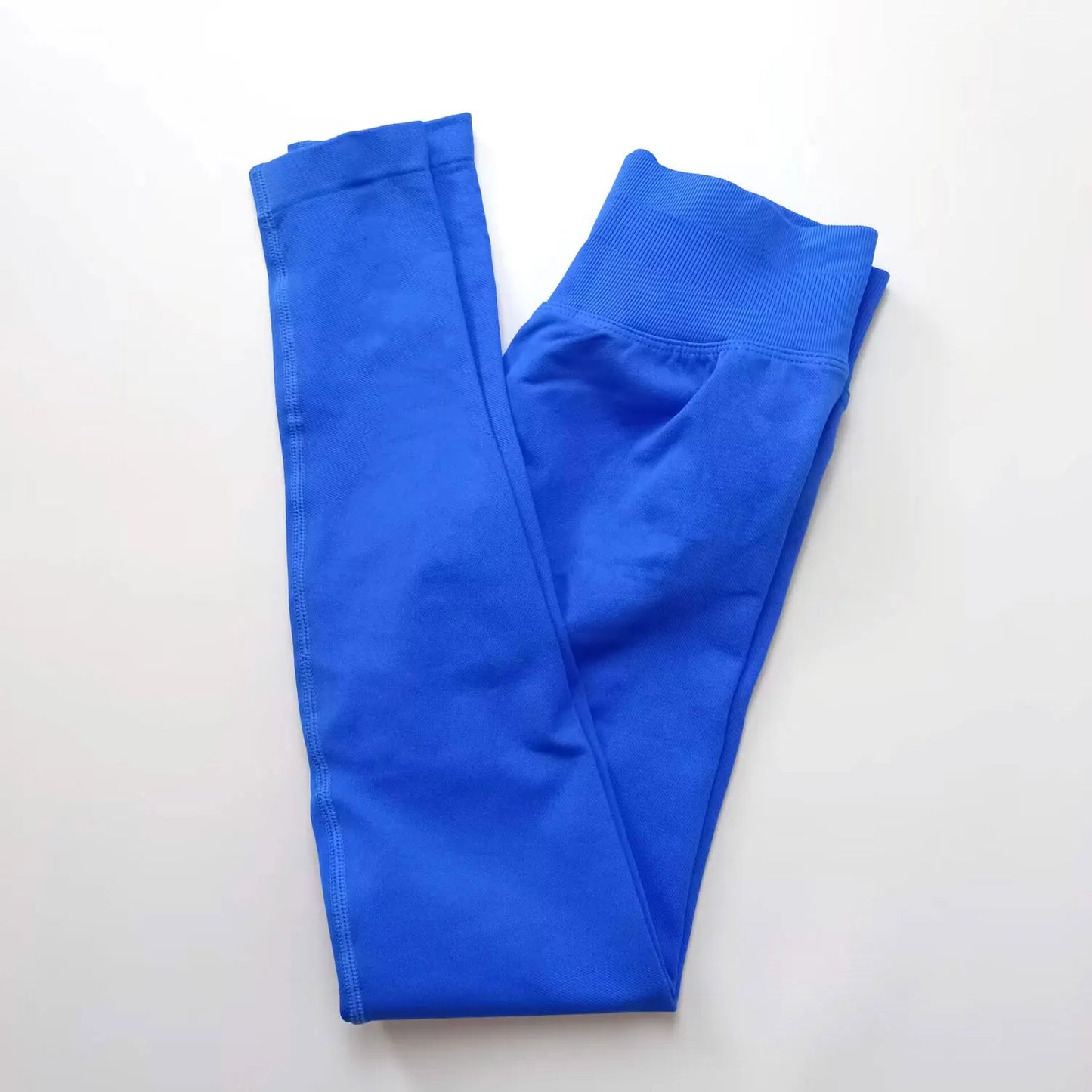 Woman wearing blue seamless gym leggings with high waist tummy control fit