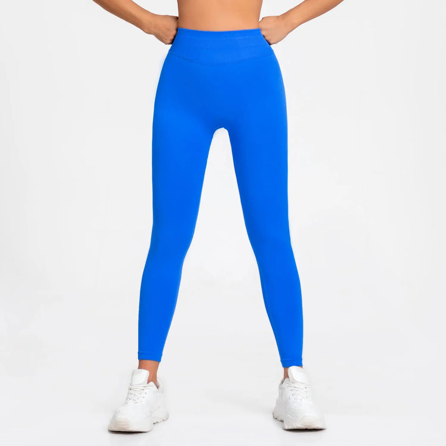 Woman wearing blue seamless gym leggings with high waist tummy control fit